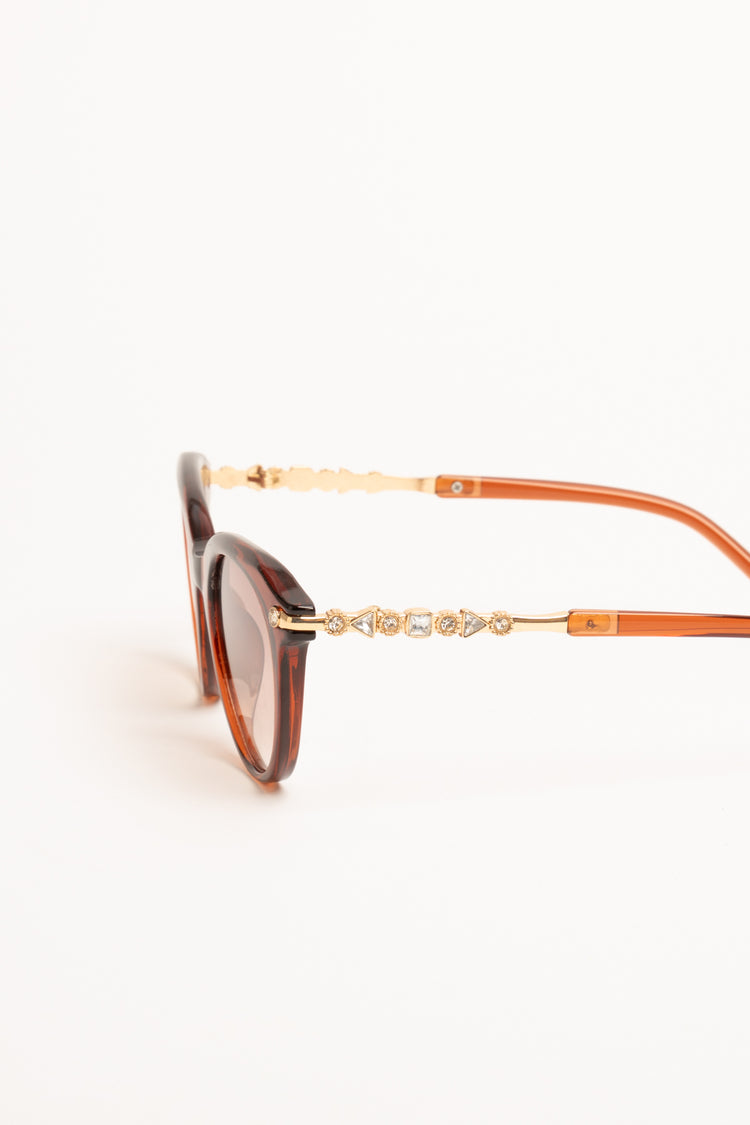 Occhiale da sole rotondi rosso mattone con strass