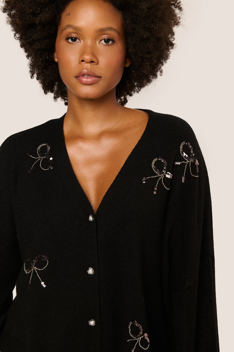 Cardigan con fiocchi in paillettes