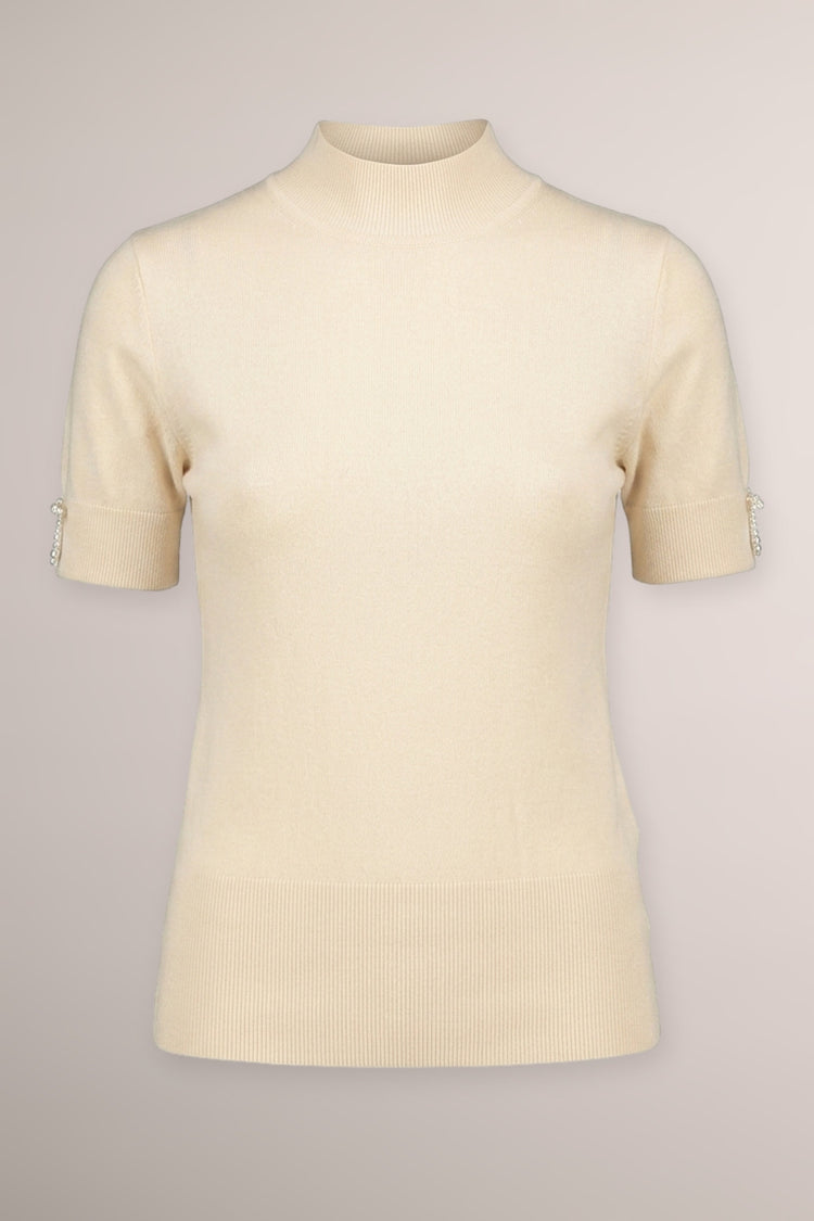 Lupetto in maglia beige con fiocchetti decorativi alle mezze maniche