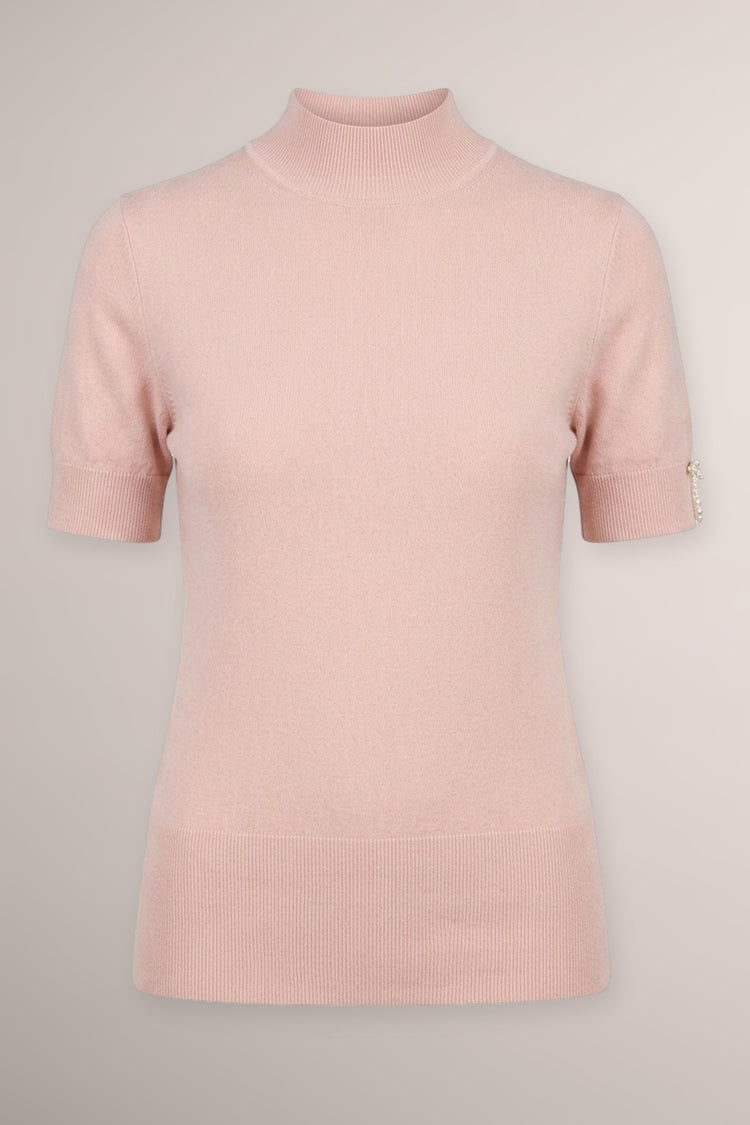 Lupetto in maglia rosa con fiocchetti decorativi alle mezze maniche