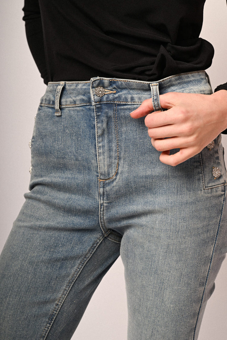 Jeans a gamba svasata in denim azzurro con bottoni gioiello