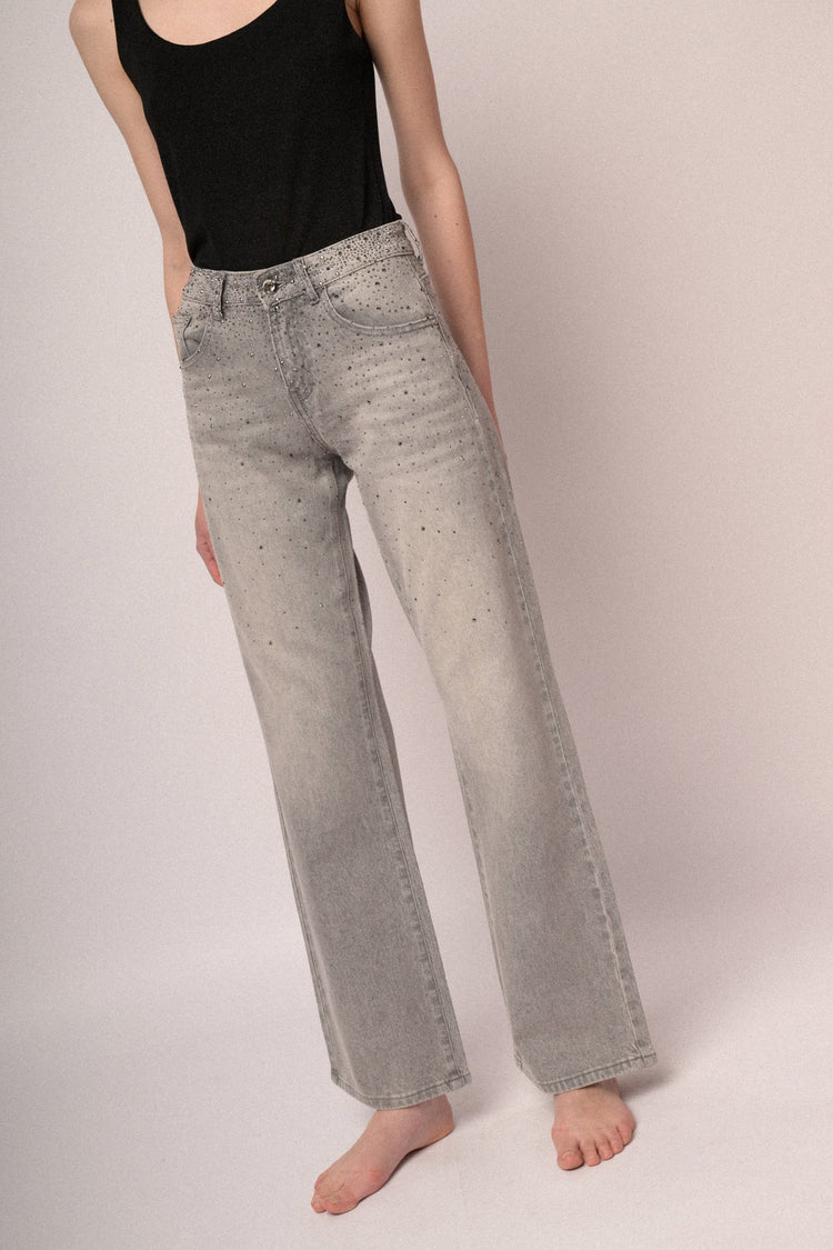 Jeans a a gamba ampia in denim grigio con decorazione strass